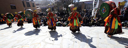 3月8日，僧人们表演传统宗教舞蹈——阿羌姆（背鼓跳神）。